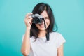 Woman smile in summer hat standing with mirrorless photo camera Royalty Free Stock Photo