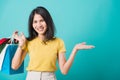 Woman smile white teeth standing wear, She holding shopping bags show hand something Royalty Free Stock Photo