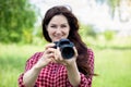 Woman smiles with a camera in her hands