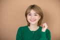 Woman smiles emotions joy on beige background