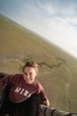Woman smiles while on a hot air balloon safari ride in the Masai Mara Reserve in Kenya, Africa. Artistic angle of photo