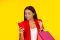 Woman smiles and looks to the message in her phone with shopping bags Royalty Free Stock Photo