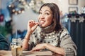 Woman smiles, winks and picks her teeth with a toothpick on a first date. Concept of bad manners and bad habits, as well as Royalty Free Stock Photo