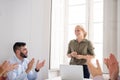 People clapping after a presentation in a meeting