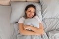 Woman smiling in bed, hugging pillow, happy morning Royalty Free Stock Photo