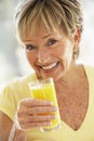 Woman Smiling At Camera Drinking Orange Juice Royalty Free Stock Photo
