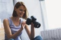 Woman smiling with a camera in her hands