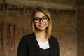 Woman smiling. Closeup portrait business girl looking at you camera smile on face, black suit formal wear, eye glasses outside Royalty Free Stock Photo