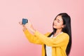 Woman smiling excited  making selfie photo, video call on smartphone Royalty Free Stock Photo