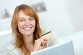 Woman smiling holding credit card Royalty Free Stock Photo