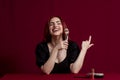 Woman smiling while holding makeup brushes standing against an isolated background. Royalty Free Stock Photo