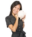 Woman smiling holding a piggy bank