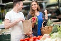 Woman smiling and holding radishes at market Royalty Free Stock Photo