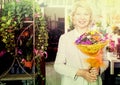 Woman smiling among multicolored flowers Royalty Free Stock Photo