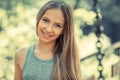 Woman smiling with perfect smile and white teeth in a park and looking at camera Royalty Free Stock Photo