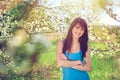 Woman smiling standing in blooming trees in spring Royalty Free Stock Photo