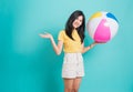 Woman smiling standing her holding beach ball in summer holiday travel Royalty Free Stock Photo