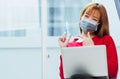 Woman smiling, student girl working with laptop computer at home office and pointing alcohol spray sanitizing on hand Royalty Free Stock Photo