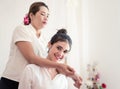 Woman smiling while taking Thai massage on her shoulder Royalty Free Stock Photo