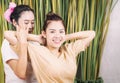 Woman smiling while taking Thai massage therapy Royalty Free Stock Photo