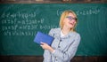 Woman smiling teacher hold book stand front chalkboard. Recommendation for college concept. Request letter Royalty Free Stock Photo