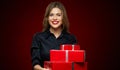 Woman smiling with teeth holding red gift box. Royalty Free Stock Photo