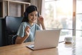 woman smiling and using laptop computer at home comfortably in living room. Smart working female people notebook Royalty Free Stock Photo