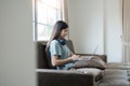 woman smiling and using laptop computer at home comfortably in living room. Smart working female people notebook Royalty Free Stock Photo