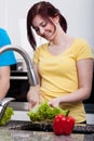 Woman smiling during washing a lettuce Royalty Free Stock Photo