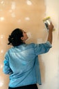 Woman smooths a plastering indoor wall Royalty Free Stock Photo