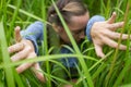 Woman sneaking through the grass.