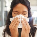 Woman, sneeze and tissue for flu, covid and safety in workplace with hands on face for health by blurred background Royalty Free Stock Photo