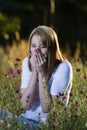 Woman sneezes with allergies Royalty Free Stock Photo