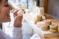 Woman sniffing organic soap while choosing at eco friendly store. Royalty Free Stock Photo