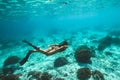 Woman snorkel underwater in beautiful tropical lagoon with coral reef