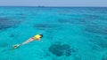 Woman snorkeling in the blue sea