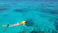 Woman snorkeling in the blue sea