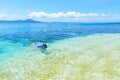 Woman snorkeling in caribbean sea, turquoise blue water, tropical island. Indonesia Banyak Islands Sumatra, tourist diving travel