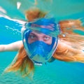 Woman snorkeling in full face mask. Female snorkel in clean turquoise sea. Royalty Free Stock Photo