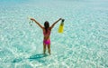 Woman with snorkeling gear stands in tropical, turquoise waters Royalty Free Stock Photo