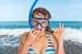 Woman with snorkeling mask for diving stands near the sea Royalty Free Stock Photo