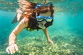 Woman snorkelling over floor of tropical sea