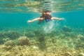 Woman snorkelling over floor of tropical sea