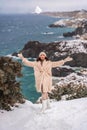 Woman snow sea. Amidst a wintry backdrop, a woman in a beige faux fur coat gleefully engages in a snowball fight, adding