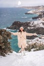 Woman snow sea. Amidst a wintry backdrop, a woman in a beige faux fur coat gleefully engages in a snowball fight, adding