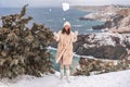 Woman snow sea. Amidst a wintry backdrop, a woman in a beige faux fur coat gleefully engages in a snowball fight, adding