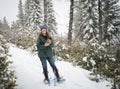 Laughing happy woman in snow shoes