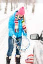 Woman snow standing with car tire chains Royalty Free Stock Photo