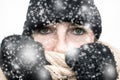 Woman in the Snow with winter wearing, wrapped in winter cap and scarf looking cold isolated on white background Royalty Free Stock Photo