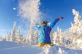 Woman snowboarder having fun in a fantastic winter forest